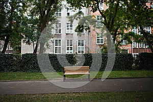 Wooden empty bench in hisotric town park.