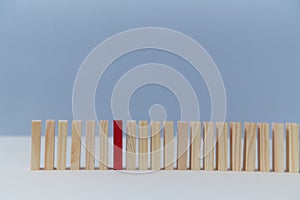 Wooden empty blocks with one red plank, copy space. Uniqueness and originality. Not like everyone. Stand out from crowd