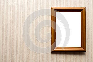 Wooden empty frame on wall with wallpaper in stripes. For your text
