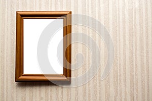 Wooden empty frame on wall with wallpaper in stripes. For your text