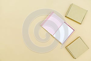 Wooden empty packaging open and closed cardboard paper craft gift box top view on beige background. Top view desk. Minimalist,