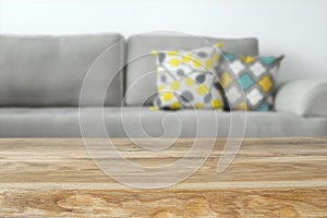 Wooden empty table in front of Living room sofa interior