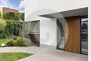 Wooden entrance door to modern house