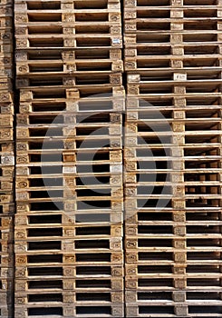 Wooden Euro pallets stacked in big industrial storehouse