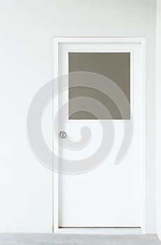Wooden factory office door with square window on white wall background, real empty interior frame for residental house or business