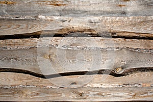 Wooden faded brown planking background with cracks and splits