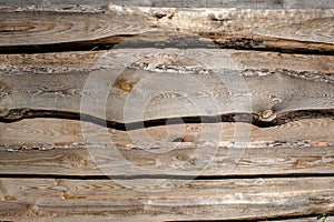 Wooden faded old brown planking background with cracks and splits