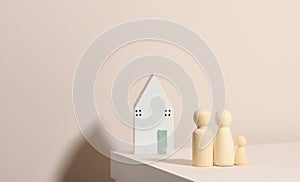 Wooden family figurines, model house on a beige background. Real estate purchase, rental concept. Moving to new apartments