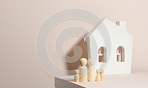 Wooden family figurines, model house on a beige background. Real estate purchase, rental concept. Moving to new apartments