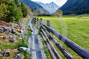 Wooden farm fence in an alpine landscape