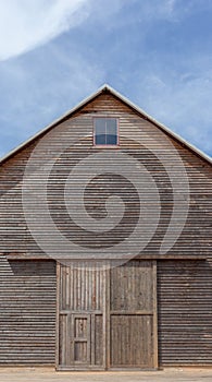 A wooden farm shed and blue sky