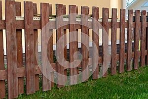 Wooden fence on a background of green grass. No people