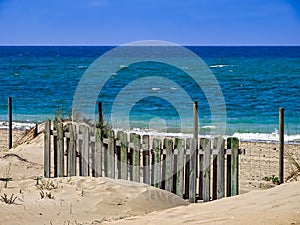 Wooden fence on the beach of Chipiona Cadiz Andalusia photo