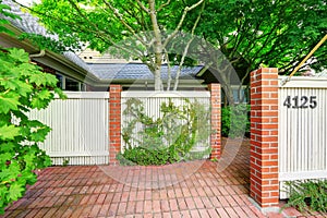 Wooden fence with brick columns and tile floor front yard