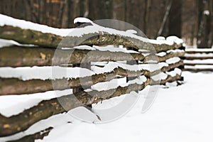 Wooden fence covered with snow