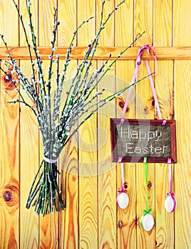 Wooden fence with 'Happy Easter', eggs and willow