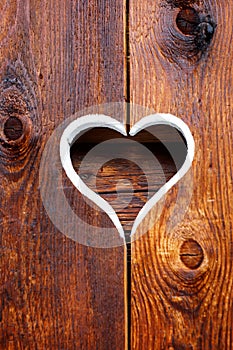 Wooden fence with heart. Part of a window in Tirol, Austria photo