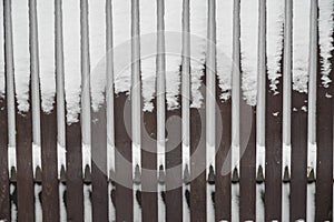 Wooden fence in hoarfrost. Severe frost and a lot of snow in winter. Close up