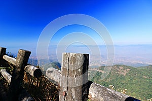 Wooden fence of Kew Mae Pan nature trail with blue mountain scenery background at Doi Inthanon , Chaing Mai , Thailand