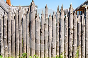Wooden fence made of logs.