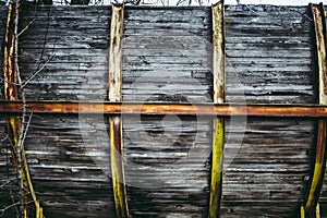 Wooden fence with metal rusted strips