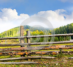 Wooden fence on mountain meadow