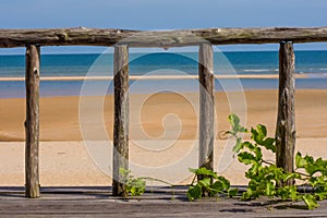 Wooden fence over looking paradise beach.