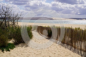 Wooden fence path access dune du pilat sand beach ocean atlantic sea in cap-ferret pyla france