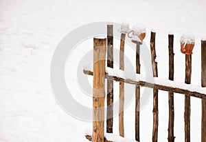 Wooden fence and pitchers. Winter
