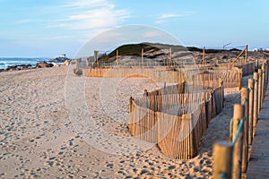 Wooden fence on sand dunes at Miramar beach on the Atlantic coast