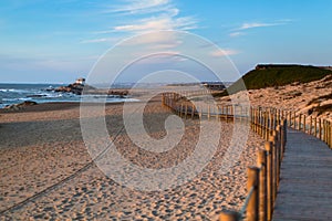 Wooden fence on sand dunes at Miramar beach on the Atlantic coast of Portugal. Nature.