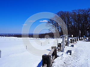Wooden fence separates the area of the snow