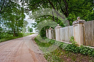 Wooden fence with stone columns and floor.