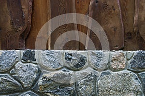 Wooden fence and stone gray wall background