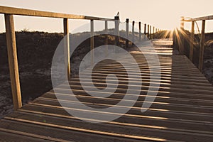 Wooden fence and walkway to beach faded. Empty path in sunlight. Walking concept. Camino de Santiago way.