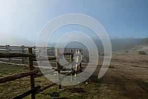 Wooden fence wrapped in fog