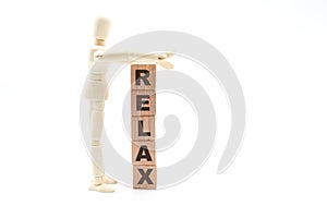 Wooden figure as businessman building Relax concept as tower of wood cubes