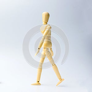 Wooden figure doll with walking action for business concept on w