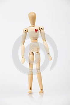 Wooden figure with red heart