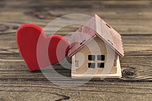 Wooden figure of a red heart with a house