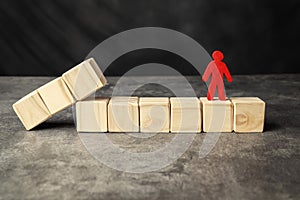 A wooden figure and a row of wooden cubes