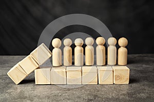 A wooden figure and a row of wooden cubes