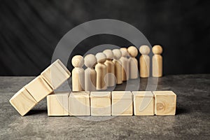 A wooden figure and a row of wooden cubes