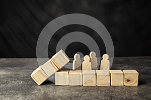 A wooden figure and a row of wooden cubes