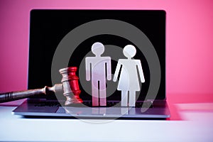 Wooden figure in shape of people and gavel on the table. Family law concept