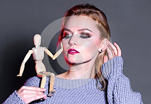 wooden figure on shoulder of girl. natural beauty. artificial fashion. vogue concept. professional visage. womens power