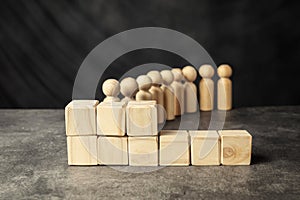 A wooden figure and a stack of wooden cubes