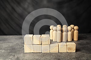A wooden figure and a stack of wooden cubes