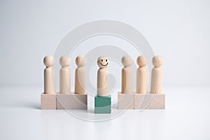 Wooden figure standing on the box for show influence and empowerment. Concept of business leadership for leader team, successful