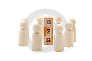 Wooden figures as business team in circle around acronym B2B Business To Business